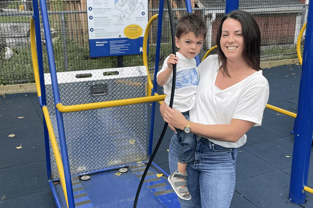 Julie standing in a playground with her son Jude
